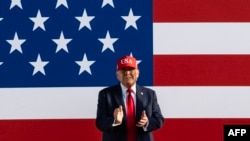 US President Donald Trump claps as he arrives to speak at the Salute to America Celebration at the Iowa State Fairgrounds in Des Moines on July 3, 2025.
