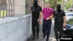 Armenia - Masked policemen escort Tigran Khachatrian, a son of Syunik Governor Surik Khachatrian, to a Yerevan court, 27Jul2015